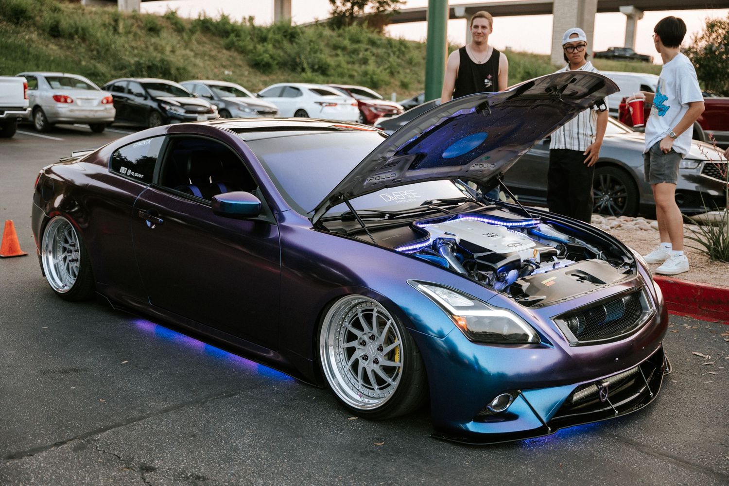 Slammed Infiniti G37 coupe in metallic blue featuring wide custom wheels.