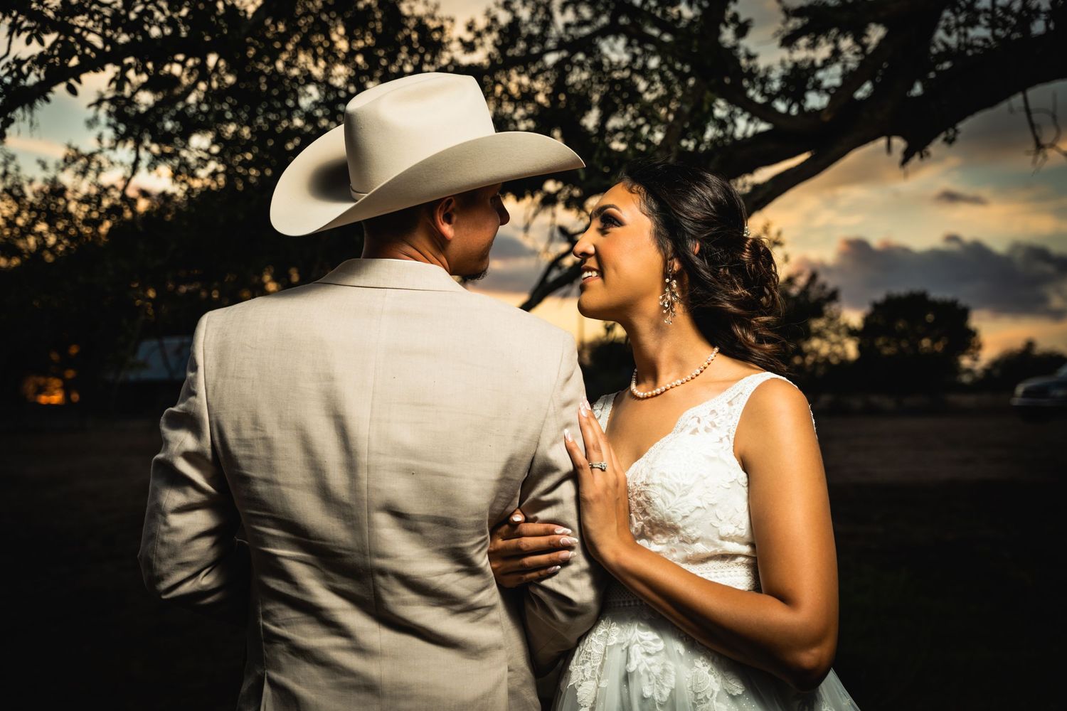 Intimate western-themed portrait session at sunset with dramatic lighting.
