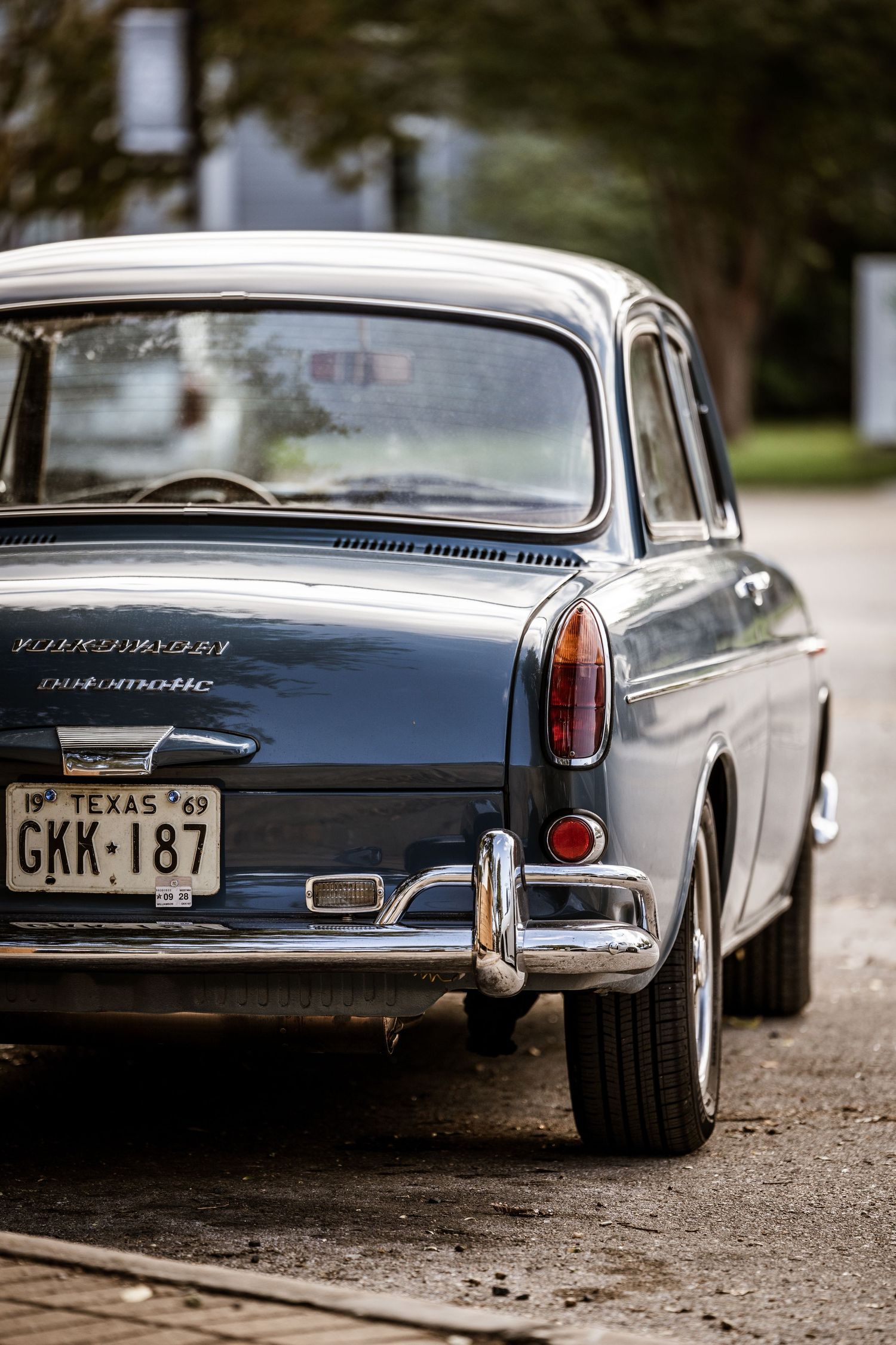 Rear view of a classic Volkswagen Type III Notchback showing vintage license plate and chrome details.