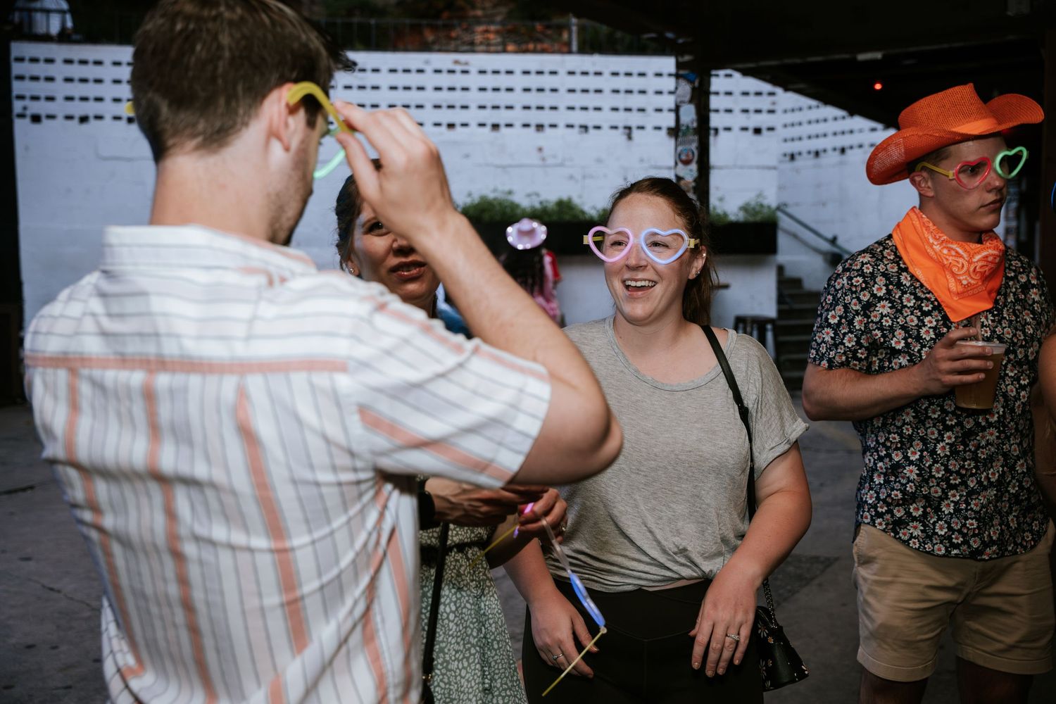 Candid moment of celebration captured at an outdoor social gathering.