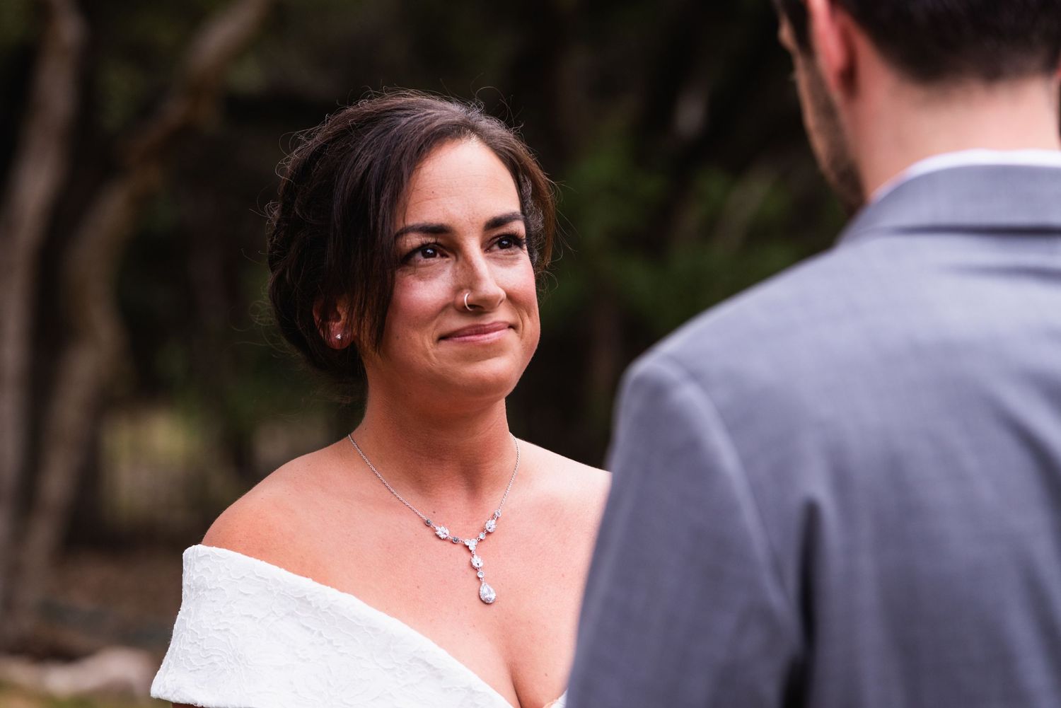 Intimate wedding moment captured in natural outdoor setting.