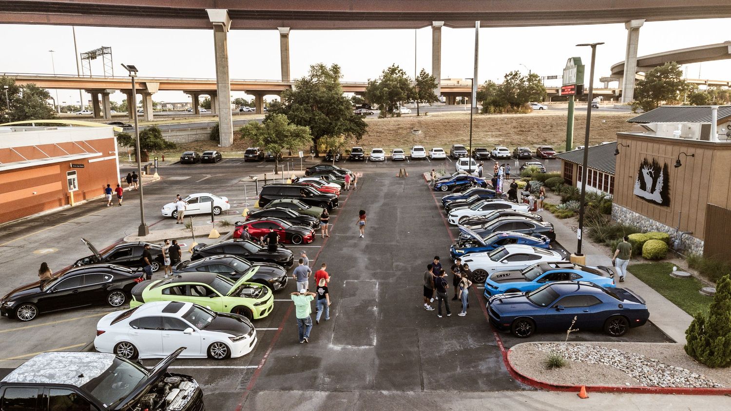 Aerial view of cars lined up in a retail parking area.