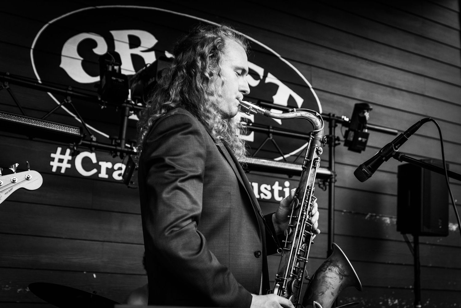 Black and white photos of musicians performing on stage with instruments and microphones.