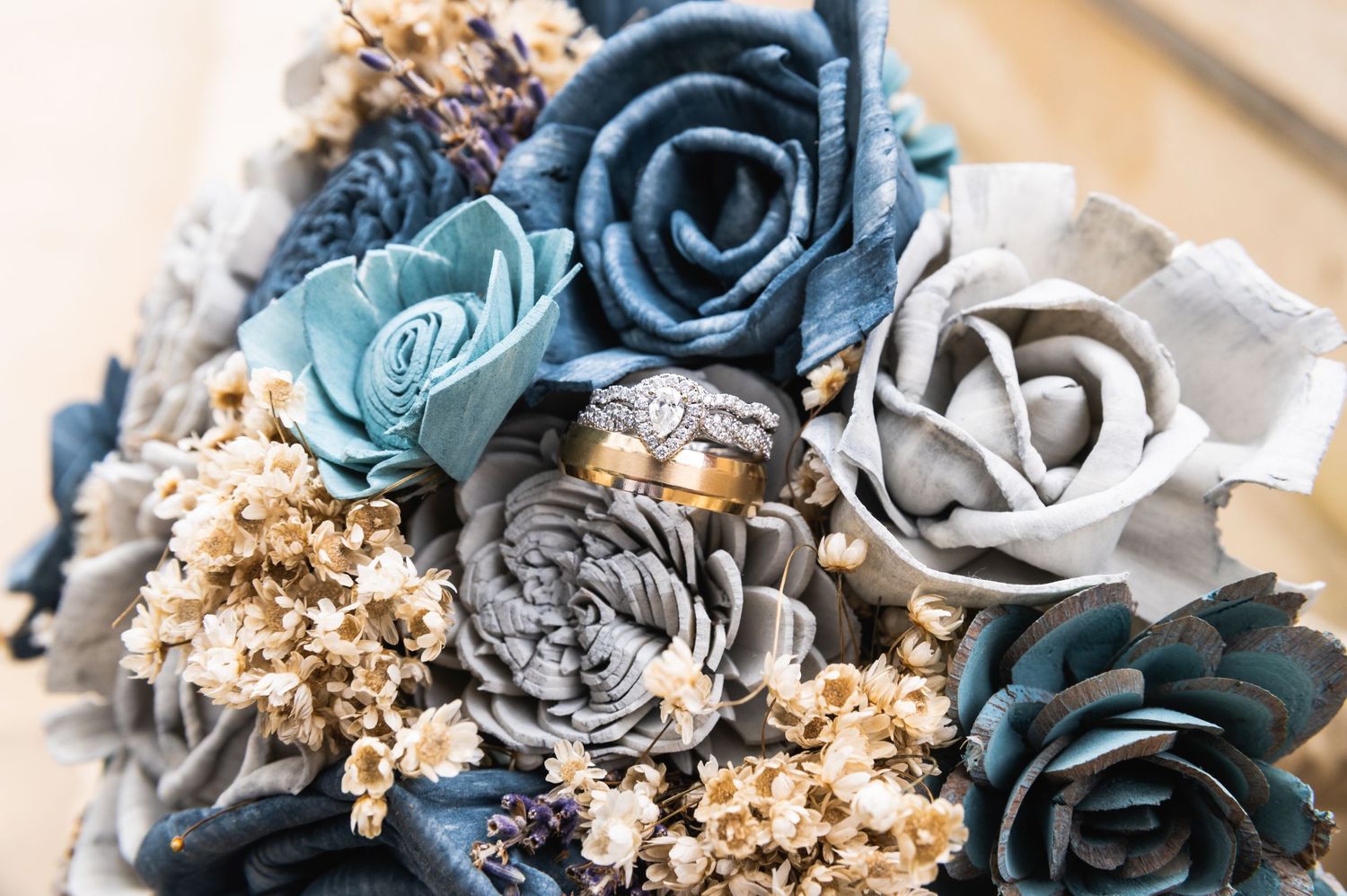 Wedding bouquet featuring blue, grey and silver roses with dried flowers accents.