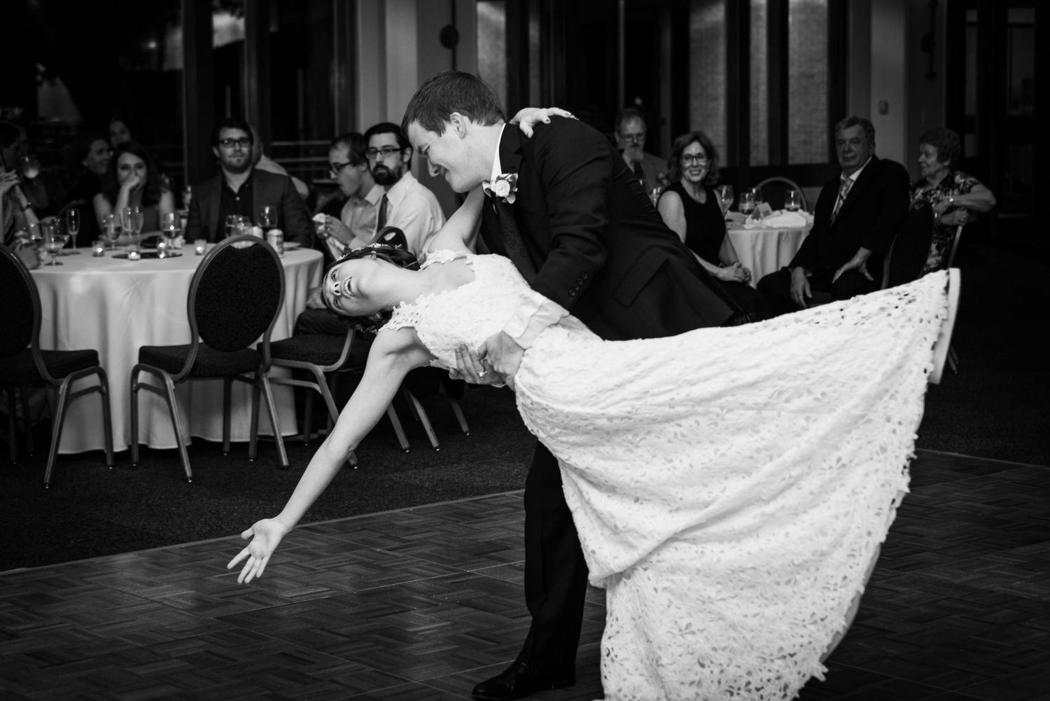 A dramatic dance dip between couple during their wedding reception.