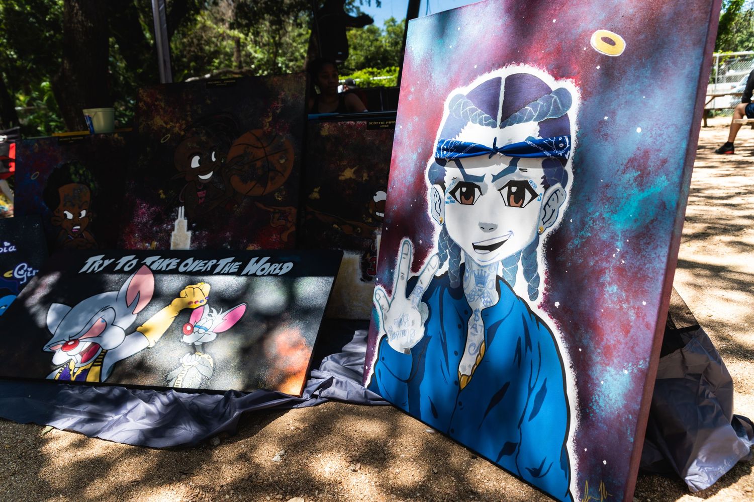 An anime-style street art painting featuring a character making a peace sign against a galaxy background.