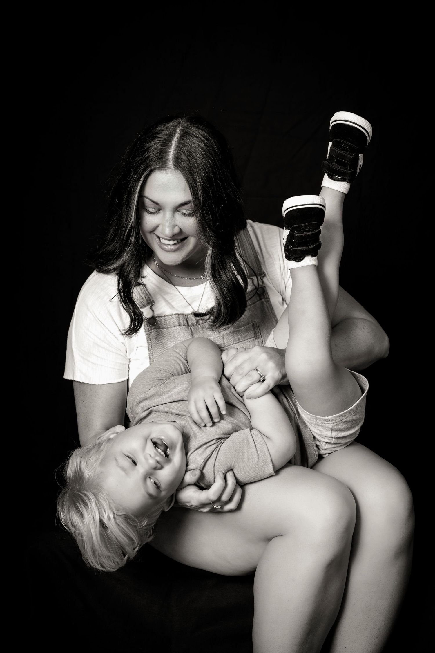 Black and white playful portrait of parent and child.