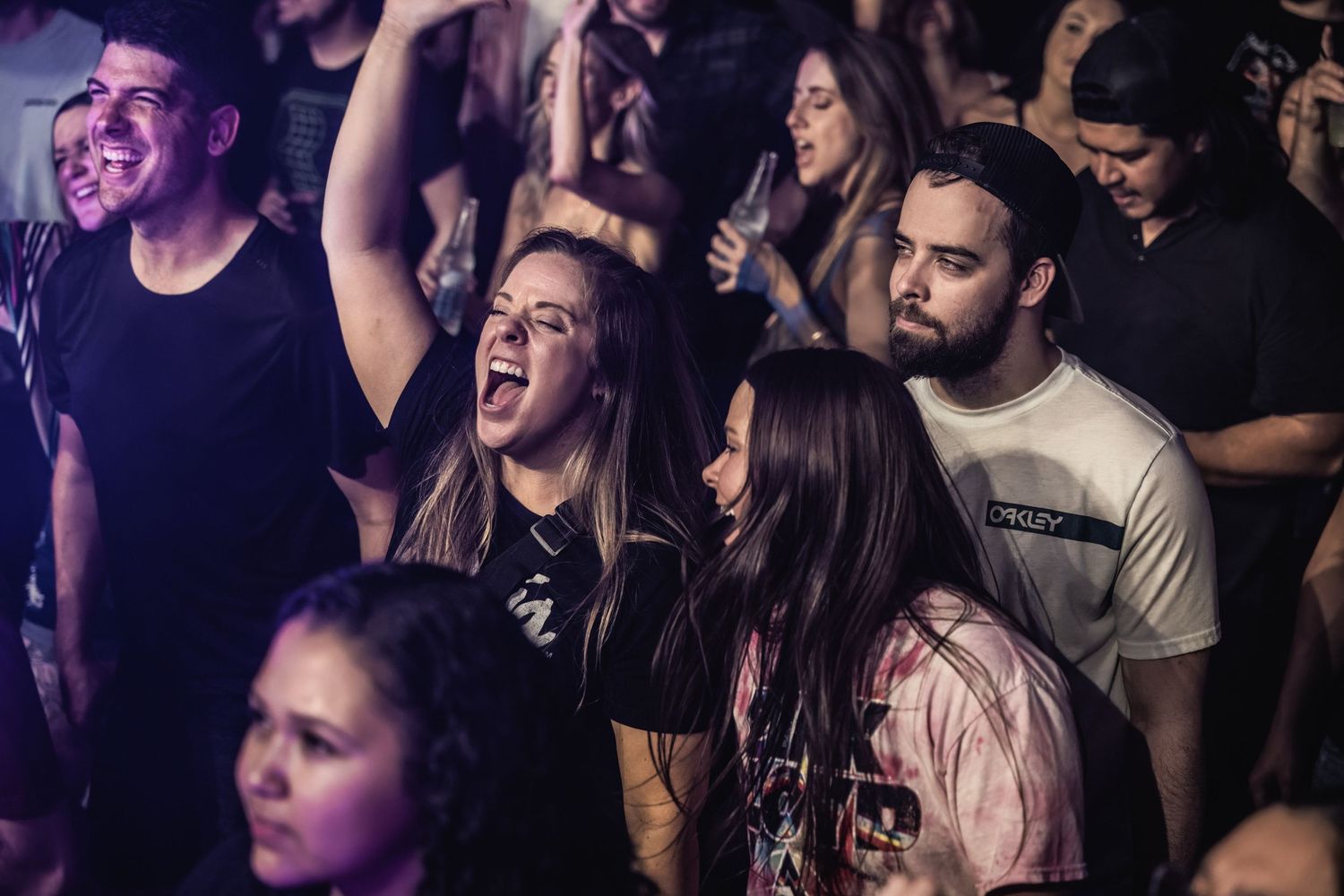 Enthusiastic crowd reacting emotionally during live concert performance.