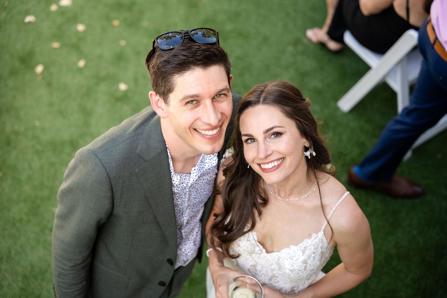 Close up of newlyweds smiling together outdoors on wedding day.
