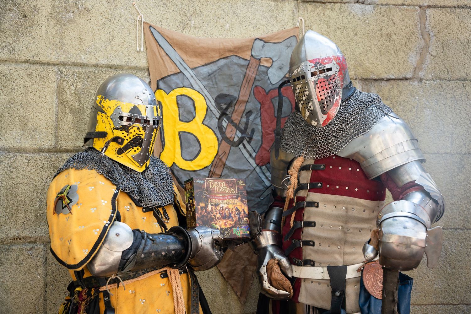 A collection of firefighter helmets and equipment displayed in a row against a concrete wall.