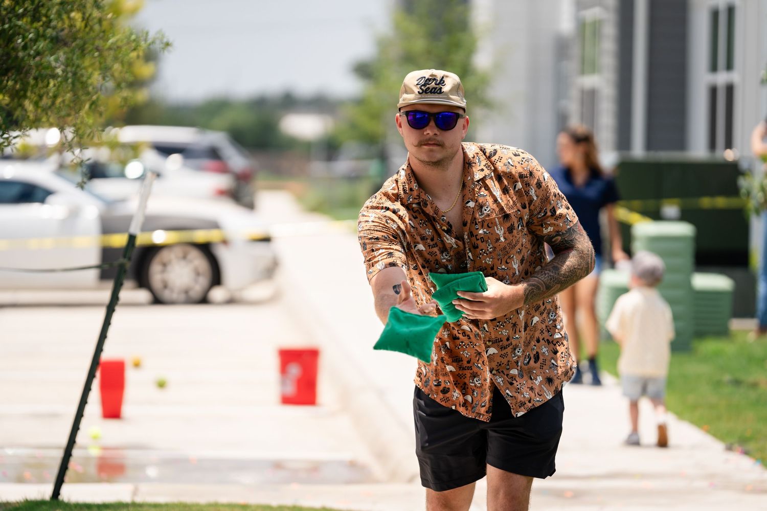 Person in camo shirt participating in outdoor summer event activities.