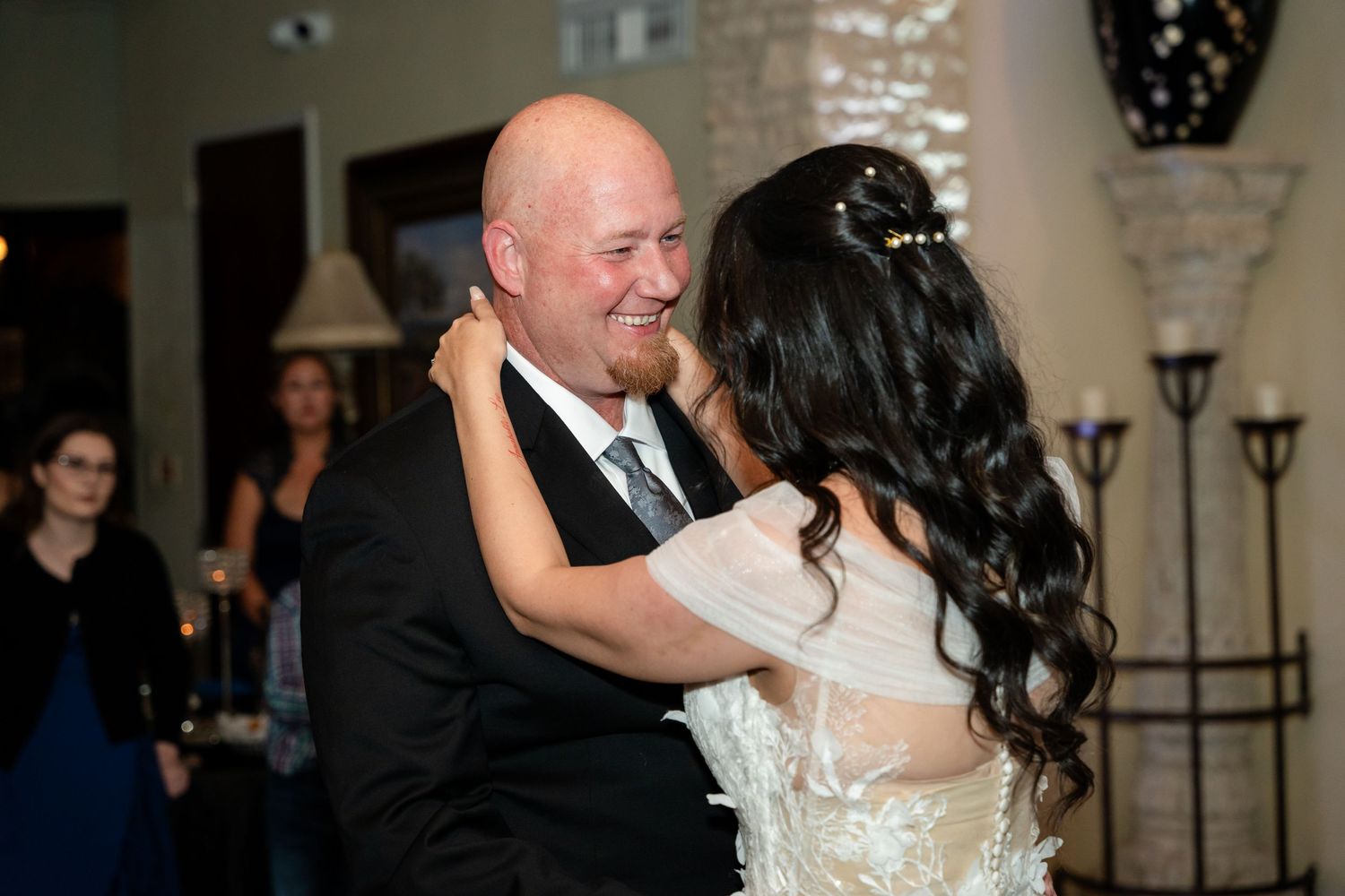 A romantic dance moment at an elegant indoor wedding reception.