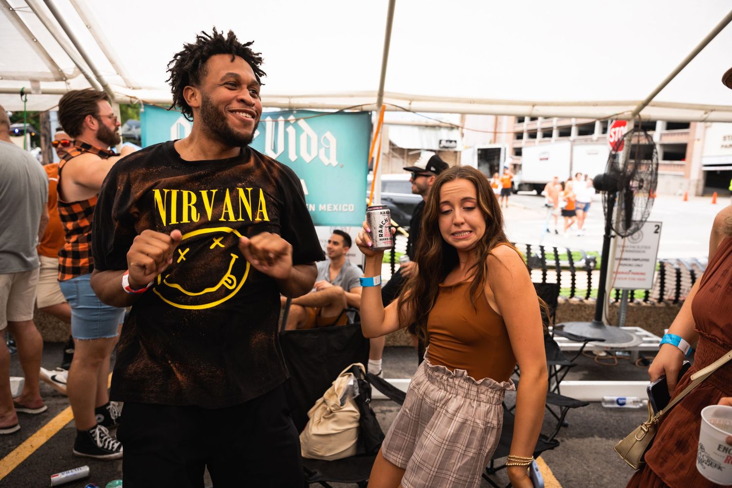 People celebrating and dancing together at an outdoor festival event.