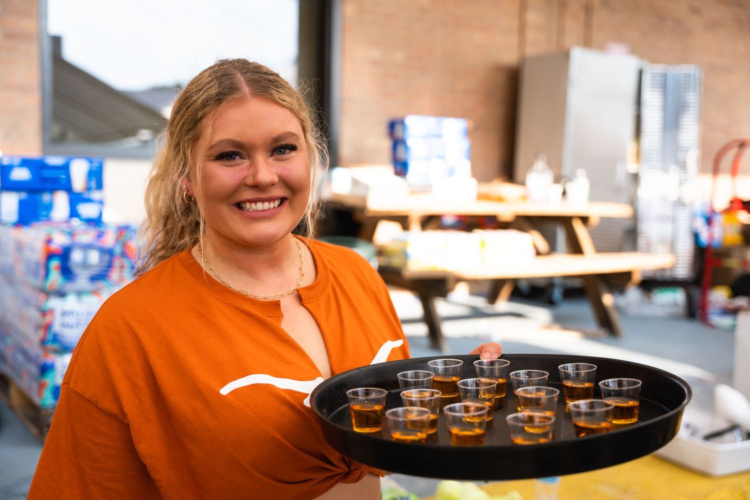 A tray of drink samples being served at a promotional event.