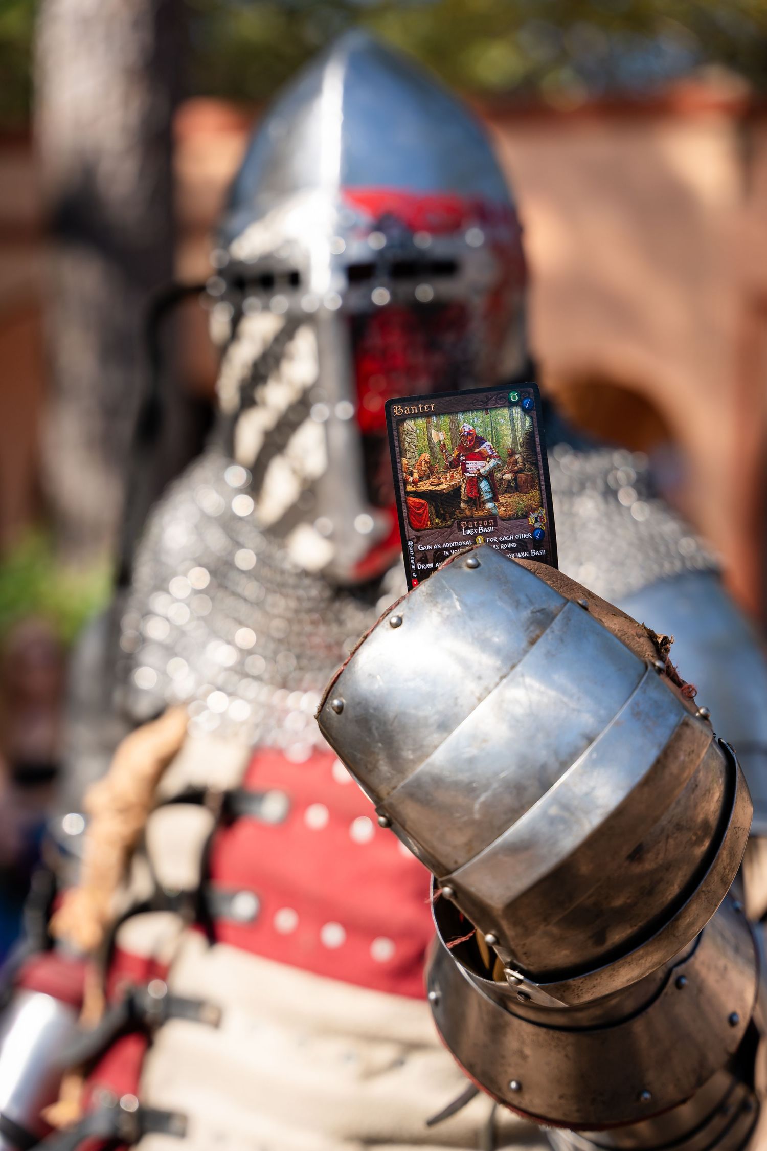 Medieval knight's helmet with visor shown in multiple close-up angles at a historical reenactment event.