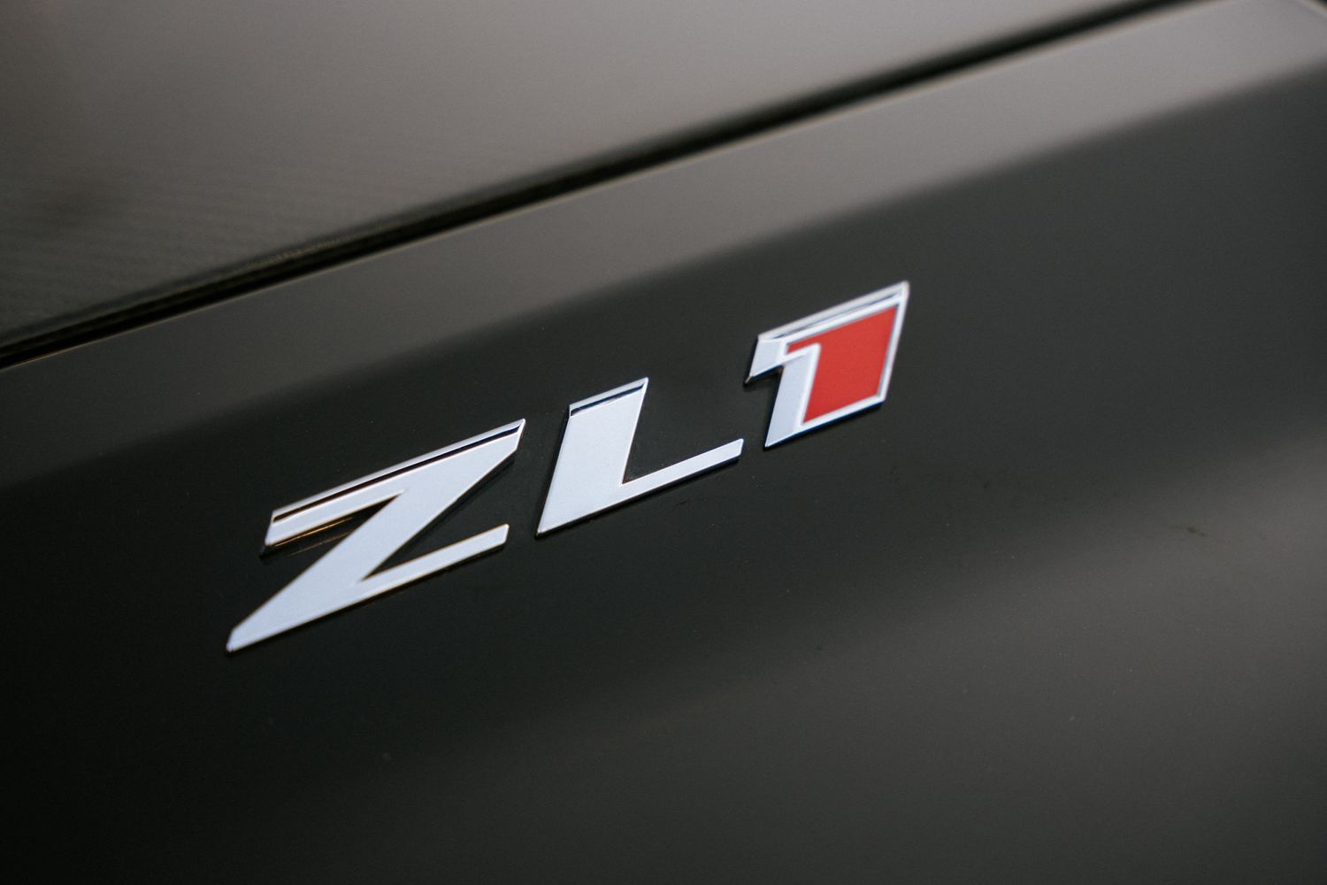 Close-up detail shot of a black ZL1 badge on a vehicle surface.