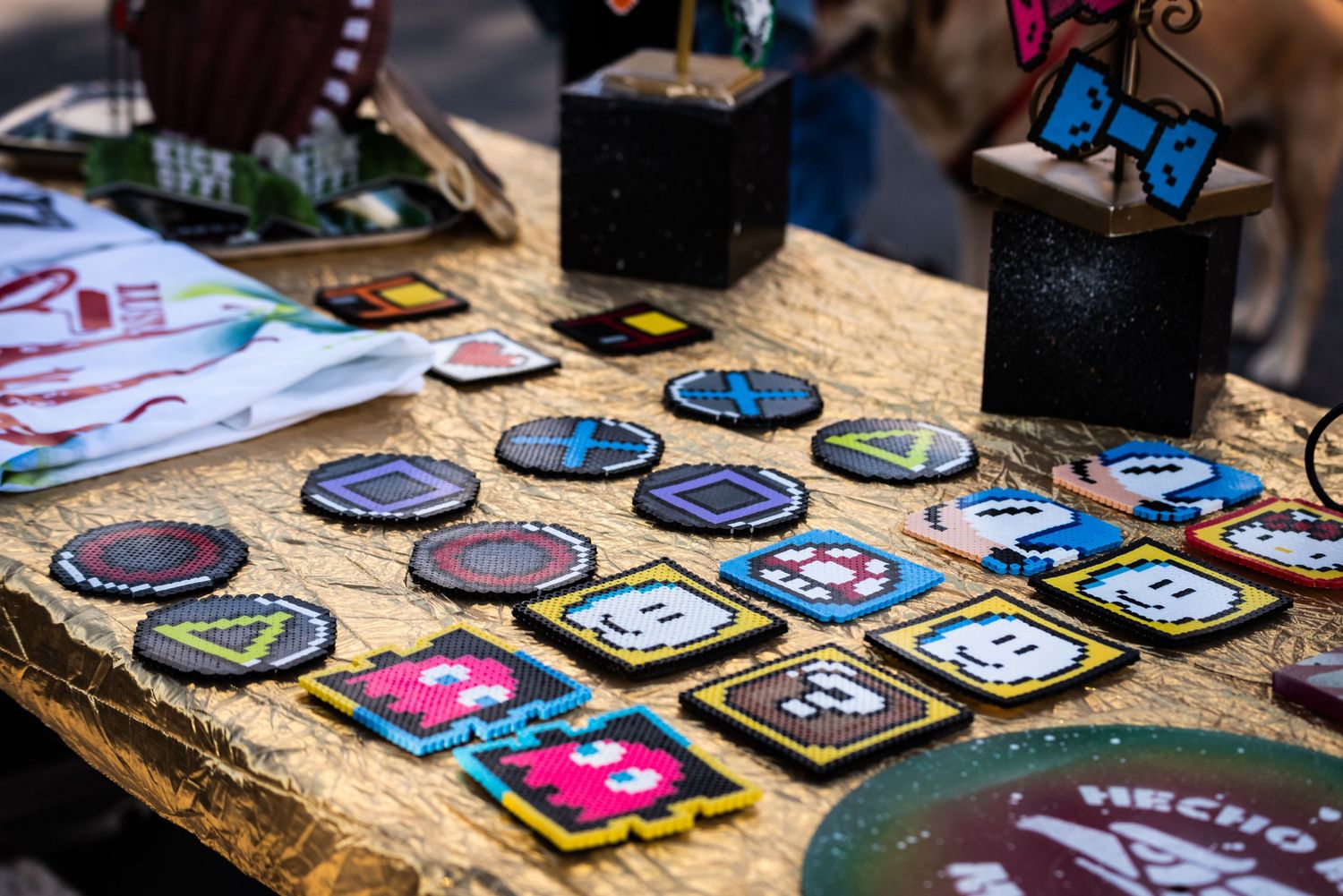 Collection of colorful patches and badges laid out on rustic wooden table.
