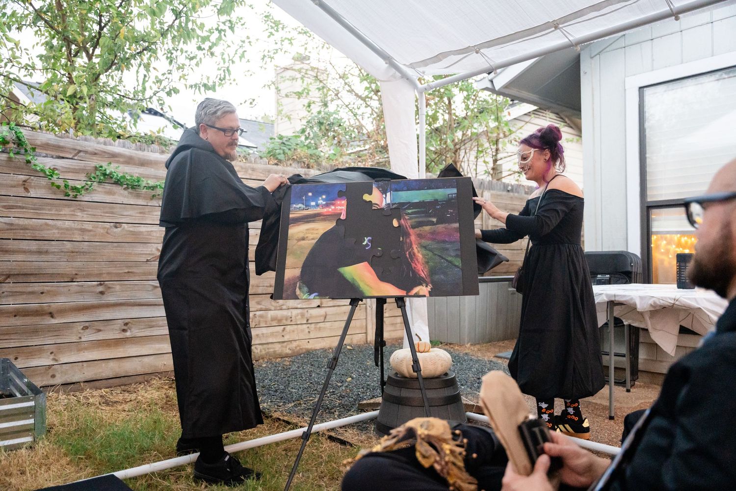 Two people interacting with artwork display during outdoor event.