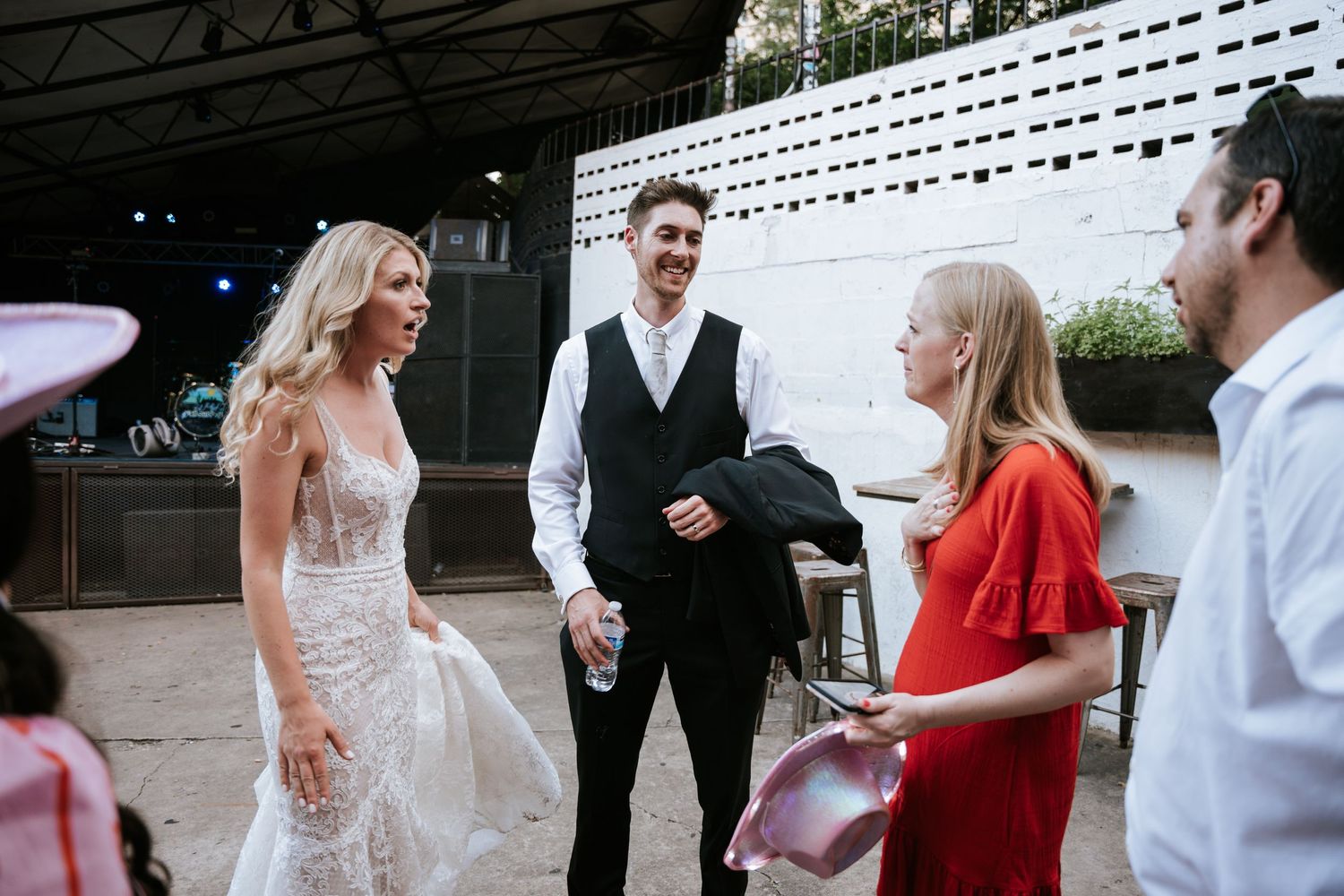 Wedding celebration scene on an outdoor venue patio.