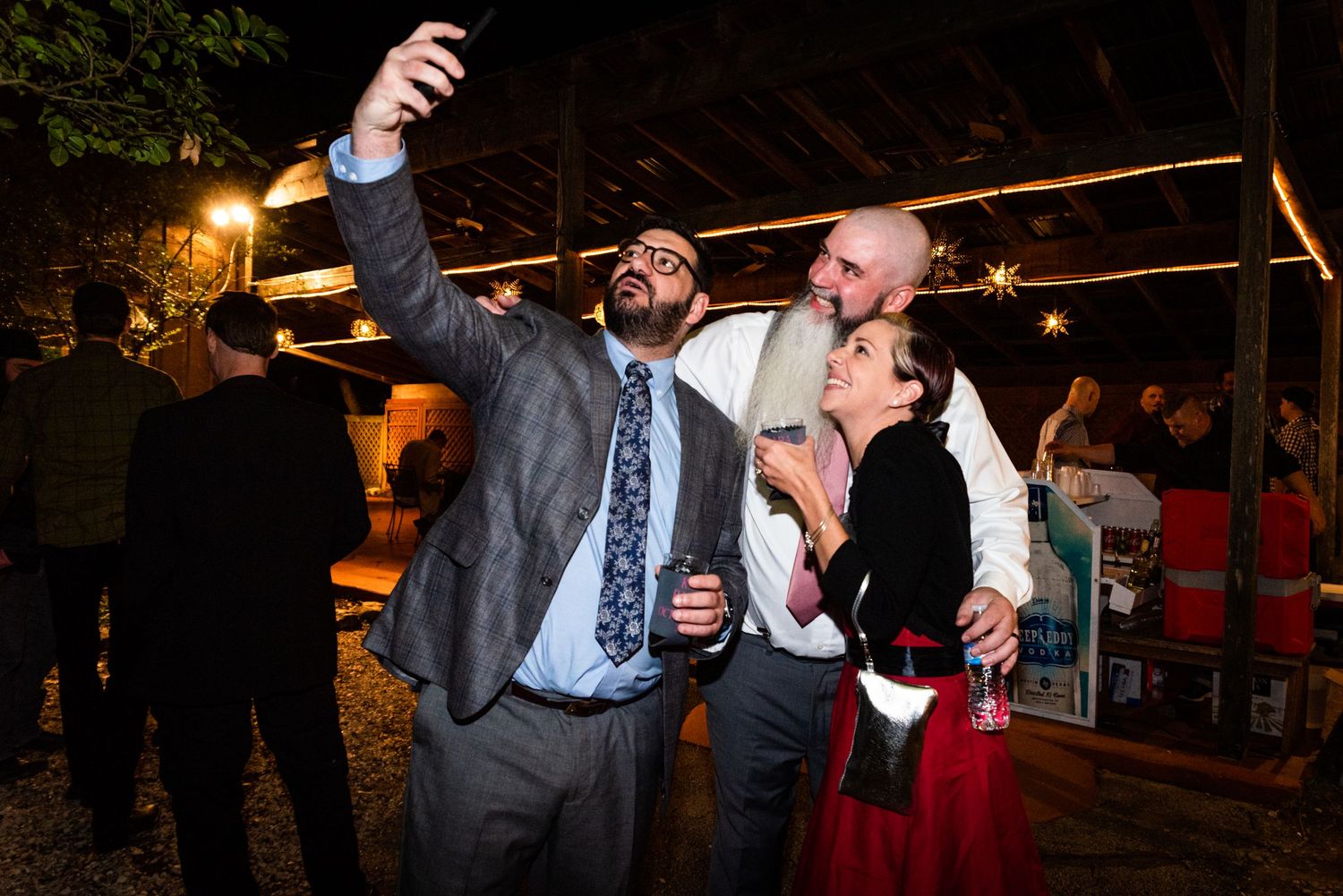 Wedding reception guests dancing and celebrating at an outdoor evening party.