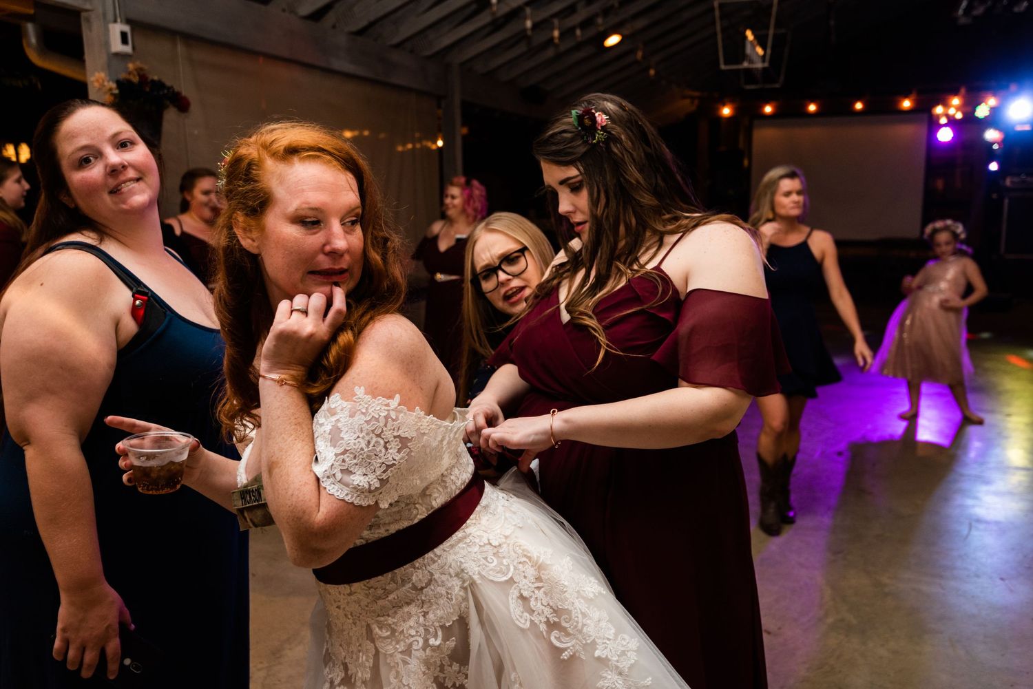 Wedding guests dancing and celebrating on the dance floor at a reception.