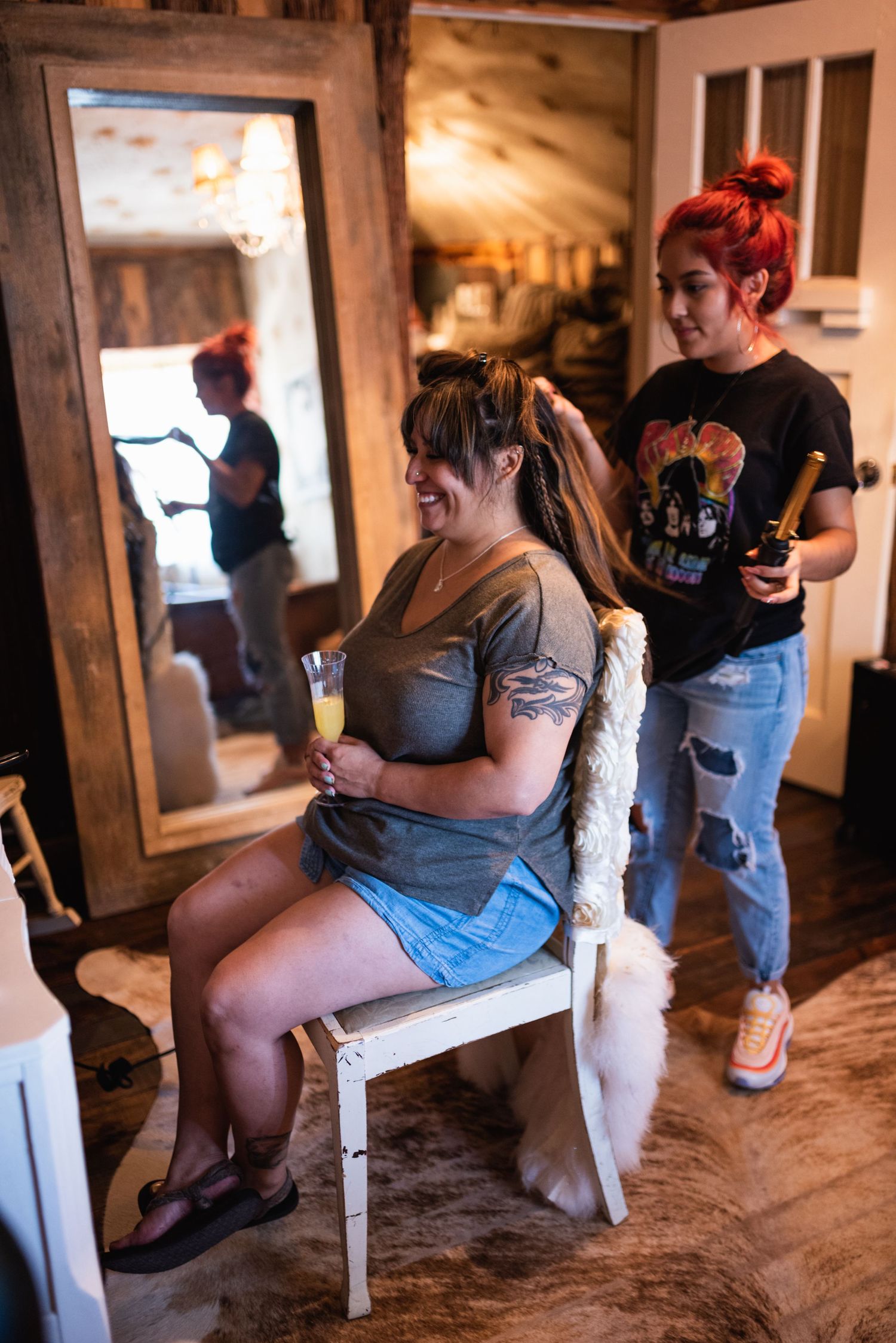 Two people in a rustic room during wedding preparations.