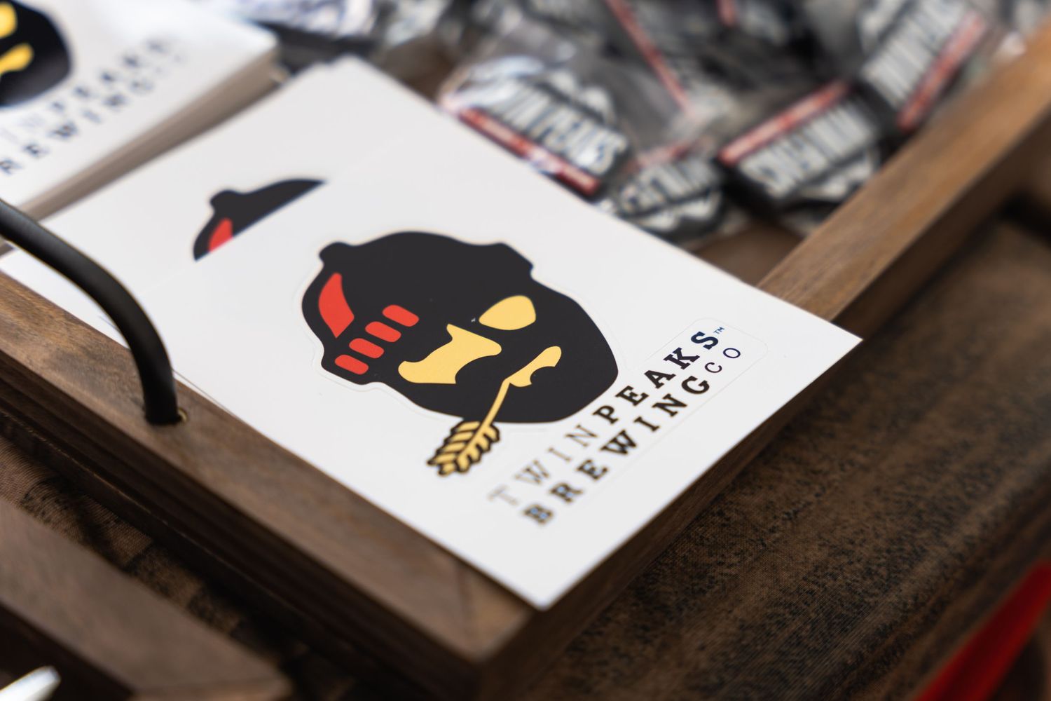 Close-up shot of a black cartoon character logo design on white paper.