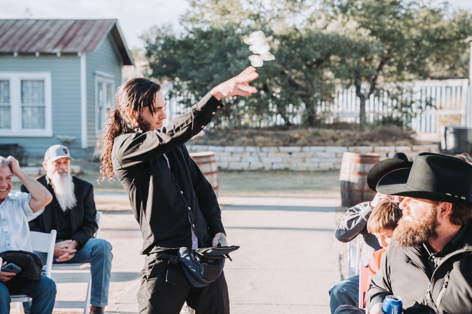 A performer gestures dramatically to the audience during an outdoor show.