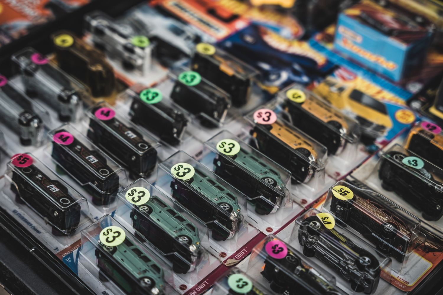 Detailed view of colorful die-cast model cars arranged in neat rows for sale.