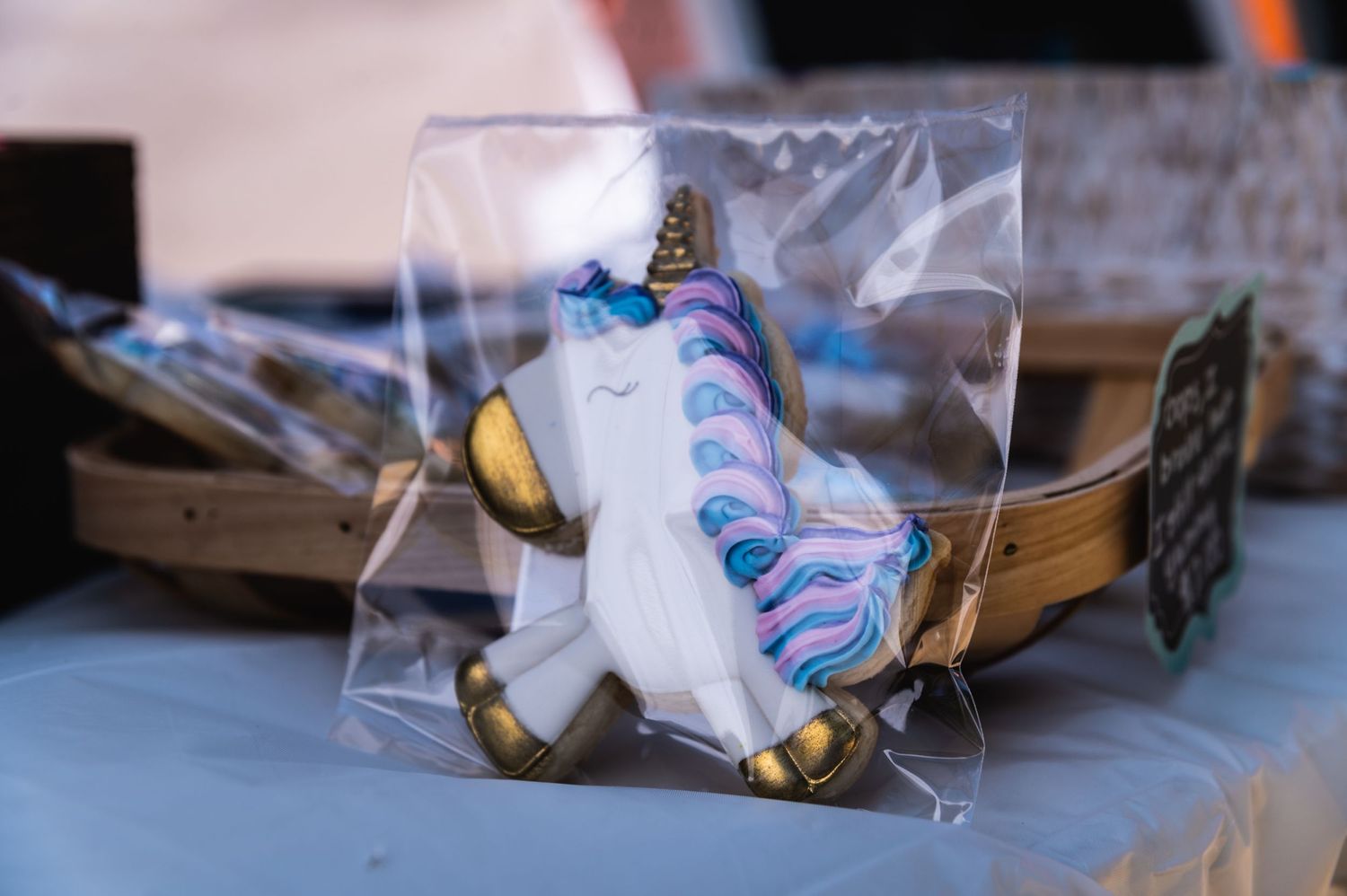 A packaged unicorn-themed cookie or baked good with blue and pink decorative details.