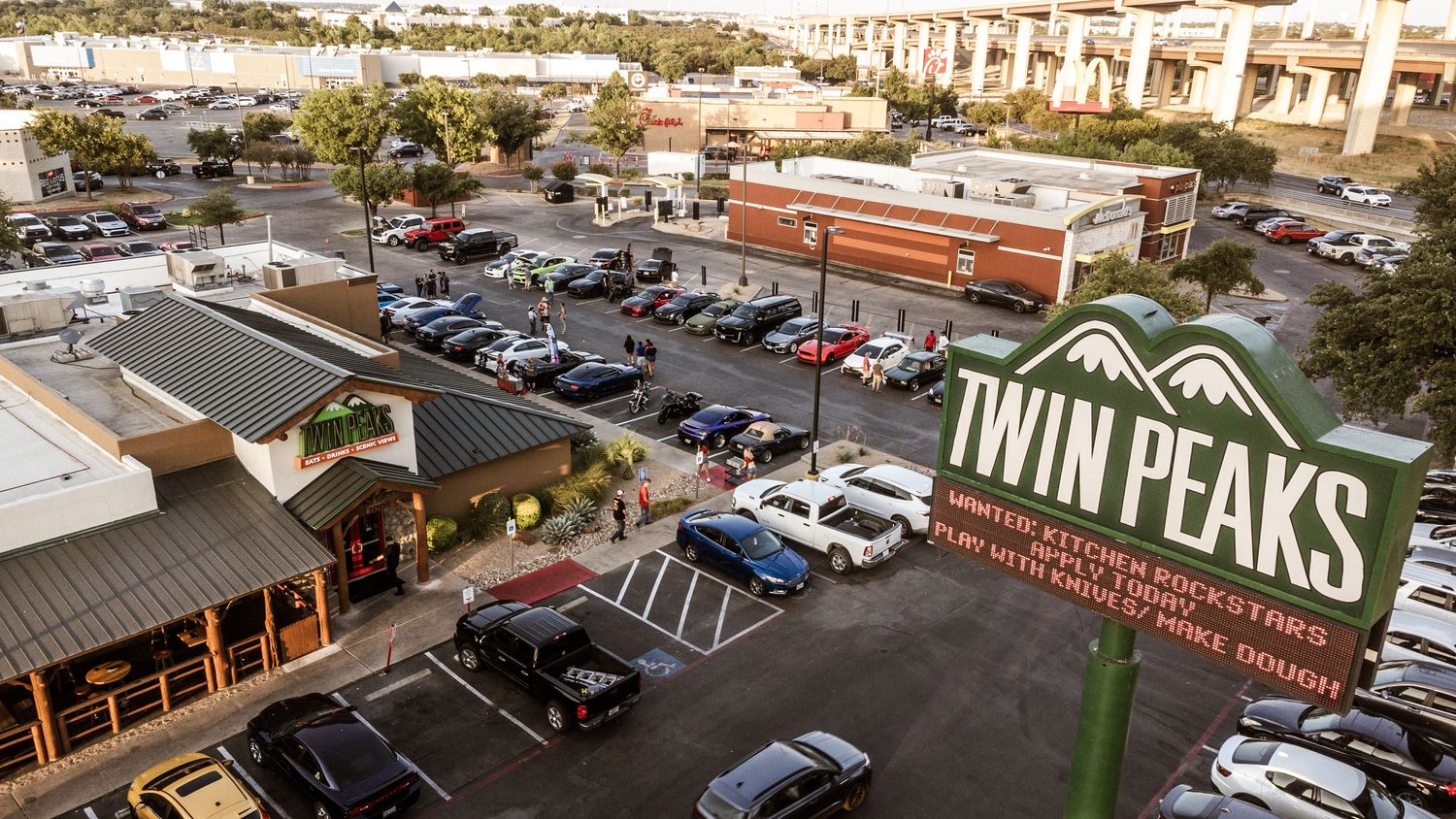 Aerial view of Twin Peaks restaurant and parking lot during daytime.