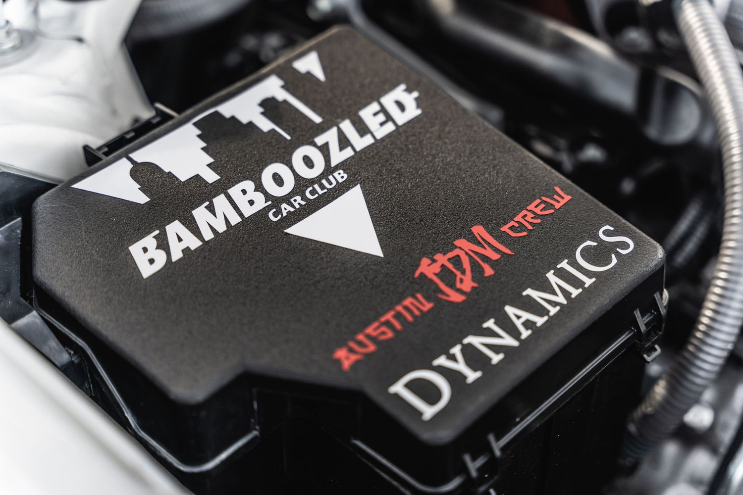 Close-up of a Bamboozler Dynamics performance engine component cover.