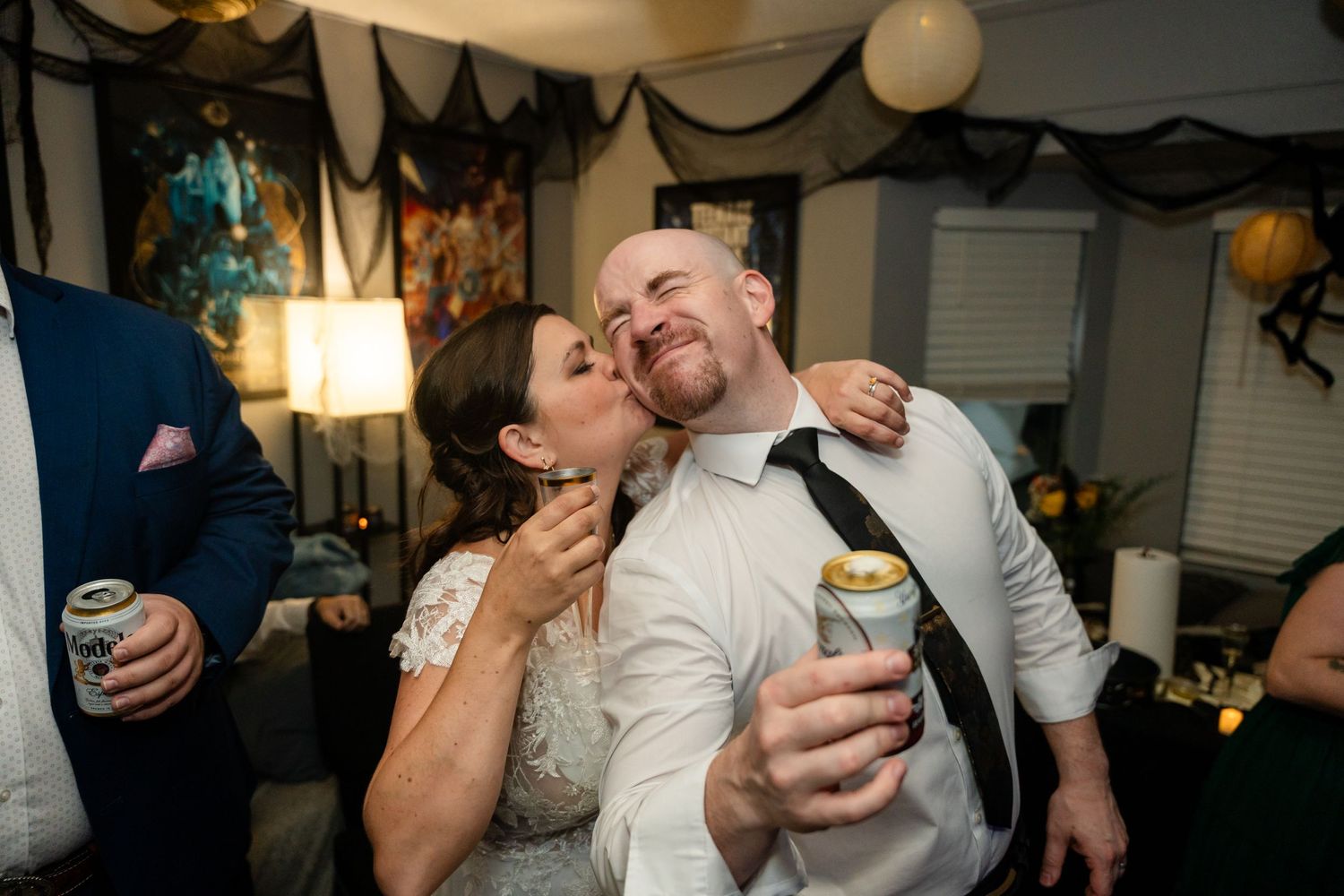 Celebratory moment at indoor party with string lights and black decor.