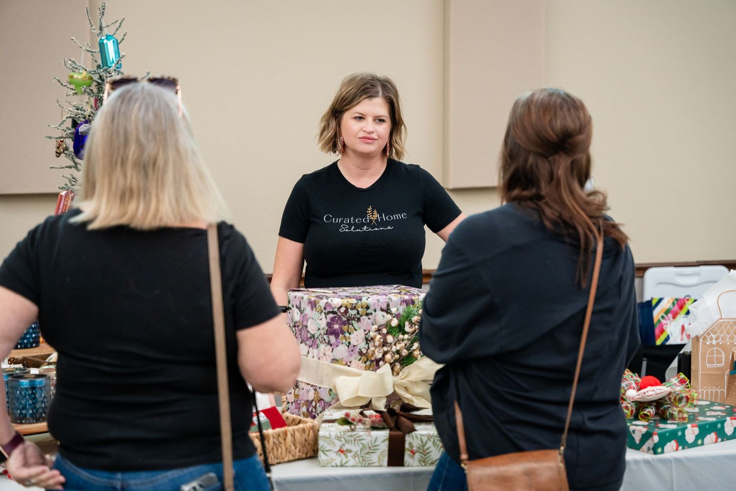 A vendor at a craft fair displaying merchandise at their booth.