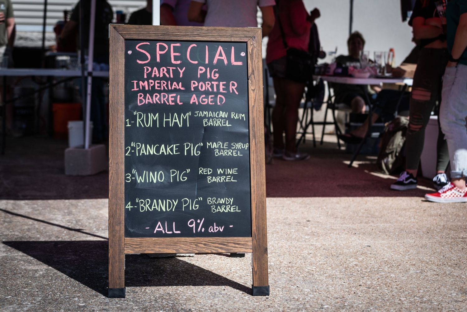 A chalkboard sign displays special daily menu items and prices at a brewery.