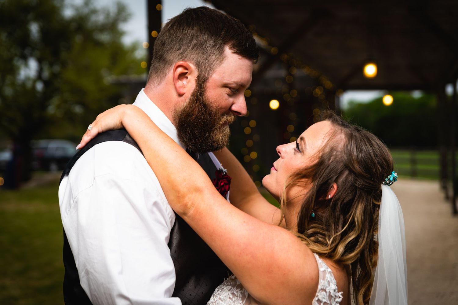 Candid moment between couple sharing laughter during evening wedding reception.