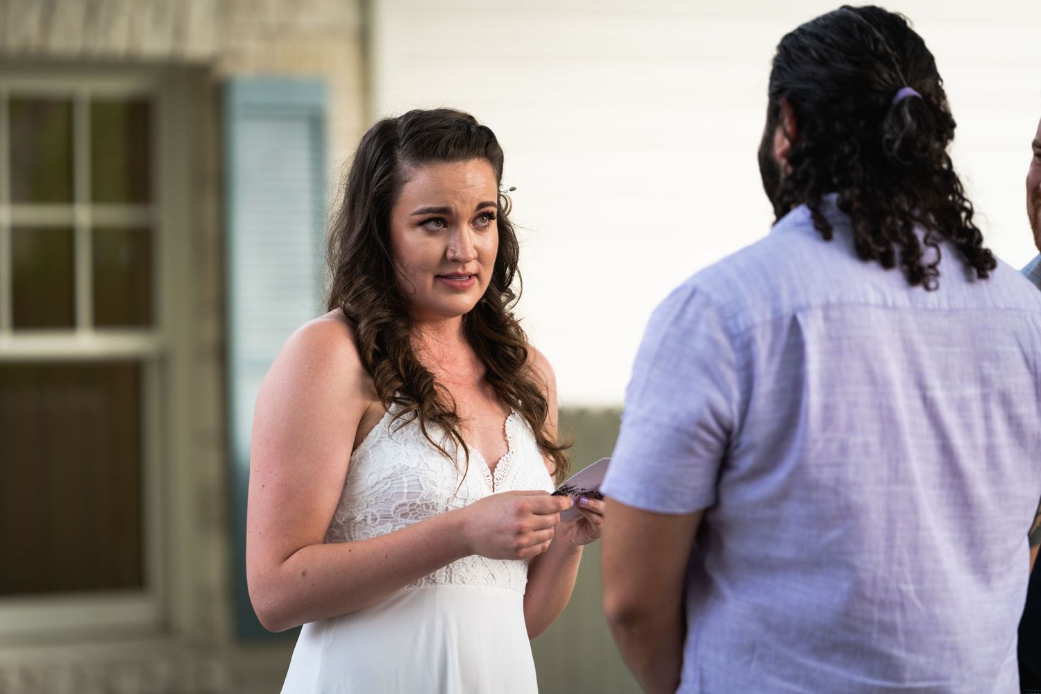 A tender moment captured between two people during an outdoor conversation.