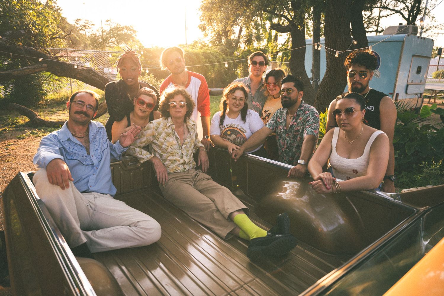 Group of friends relaxing together on outdoor furniture during sunset.