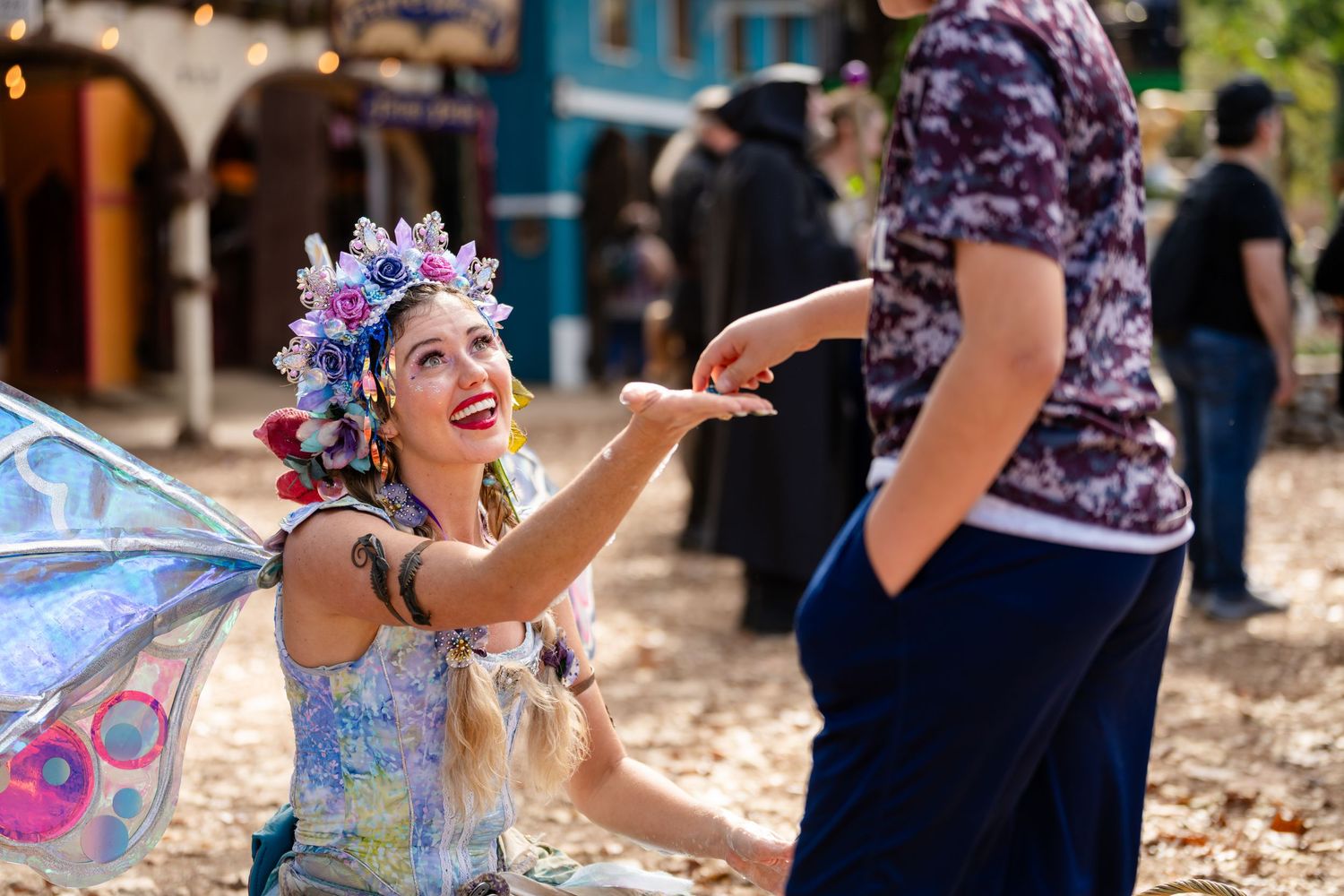 People enjoying a lively outdoor dance party with colorful decorations and festive atmosphere.