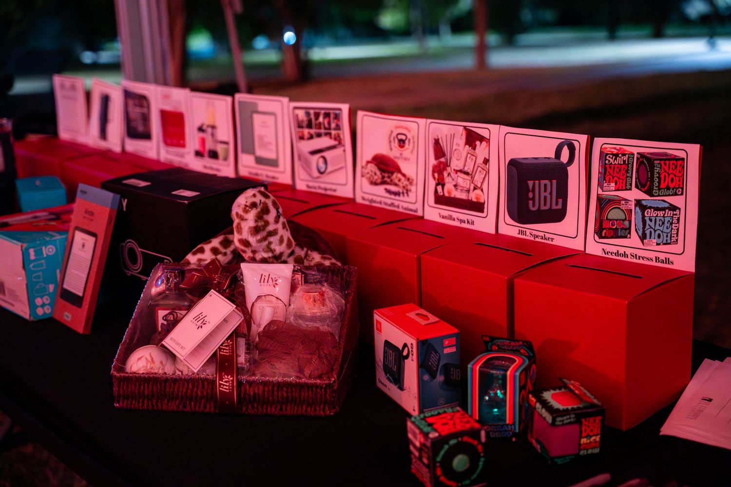 A series of vintage red fire trucks and emergency vehicles displayed in a row at a museum or exhibition.
