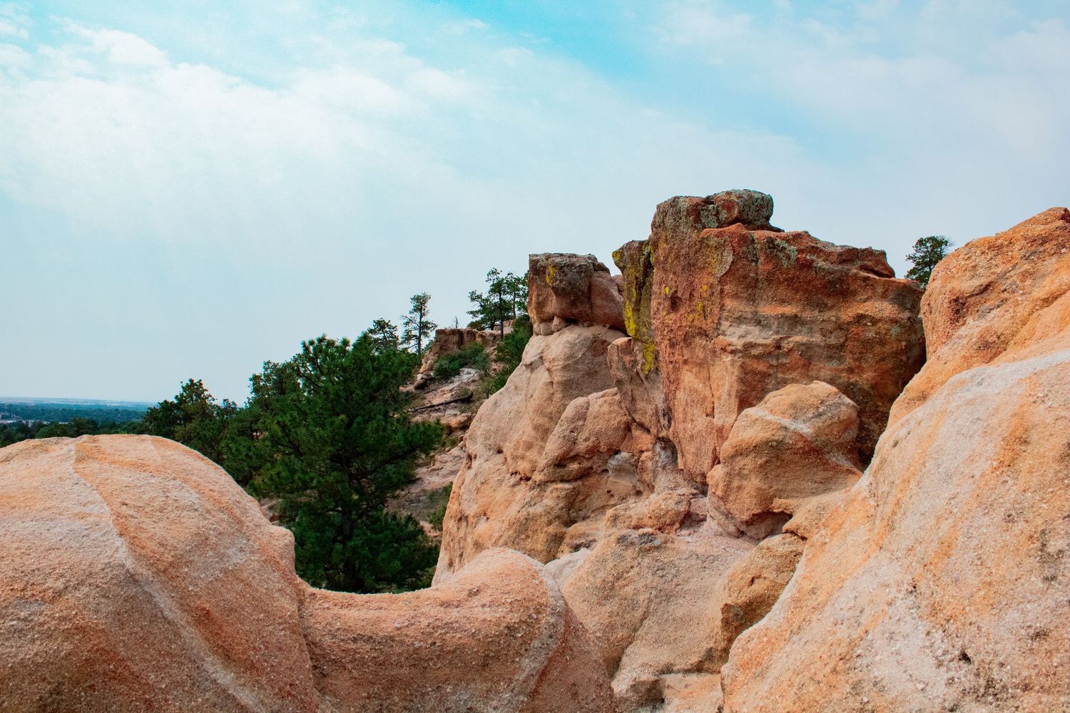 Panoramic view of red rock formations against a bright blue sky.