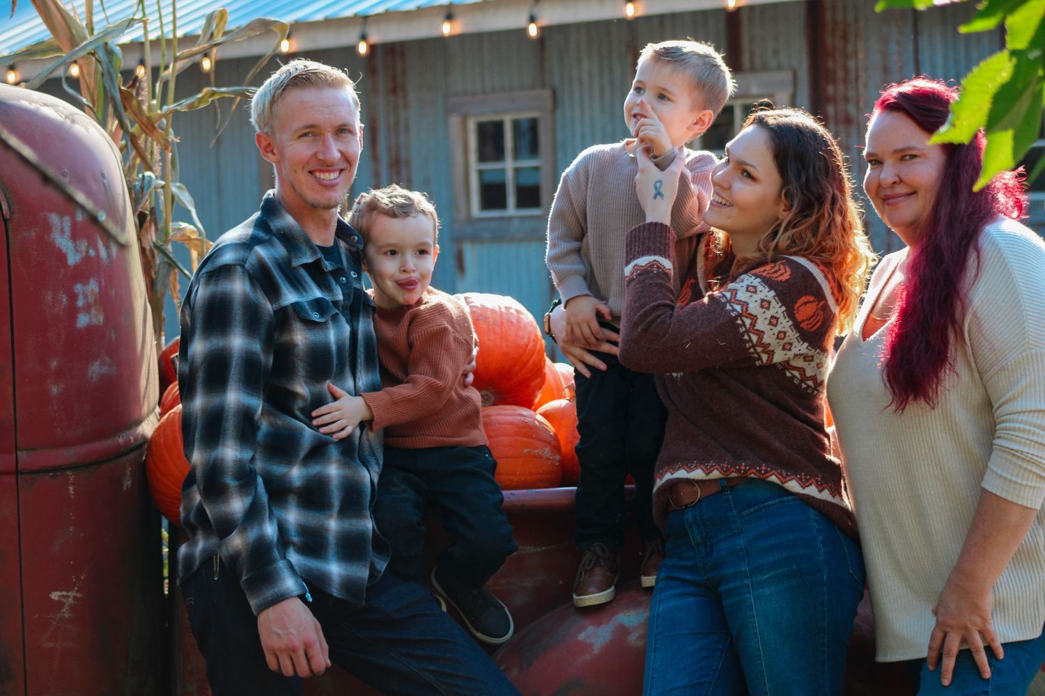 Outdoor gathering with pumpkins and casual conversation in natural lighting.
