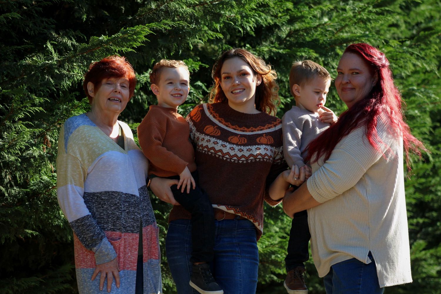 A group enjoying an outdoor fall day in nature wearing casual clothing and sweaters.