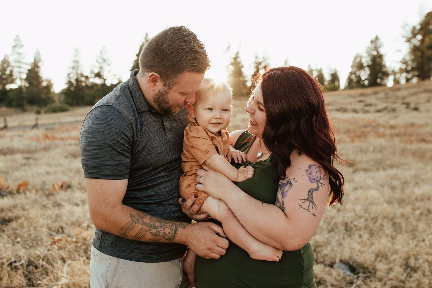 Family shares tender moments together in a rustic outdoor setting during golden hour.