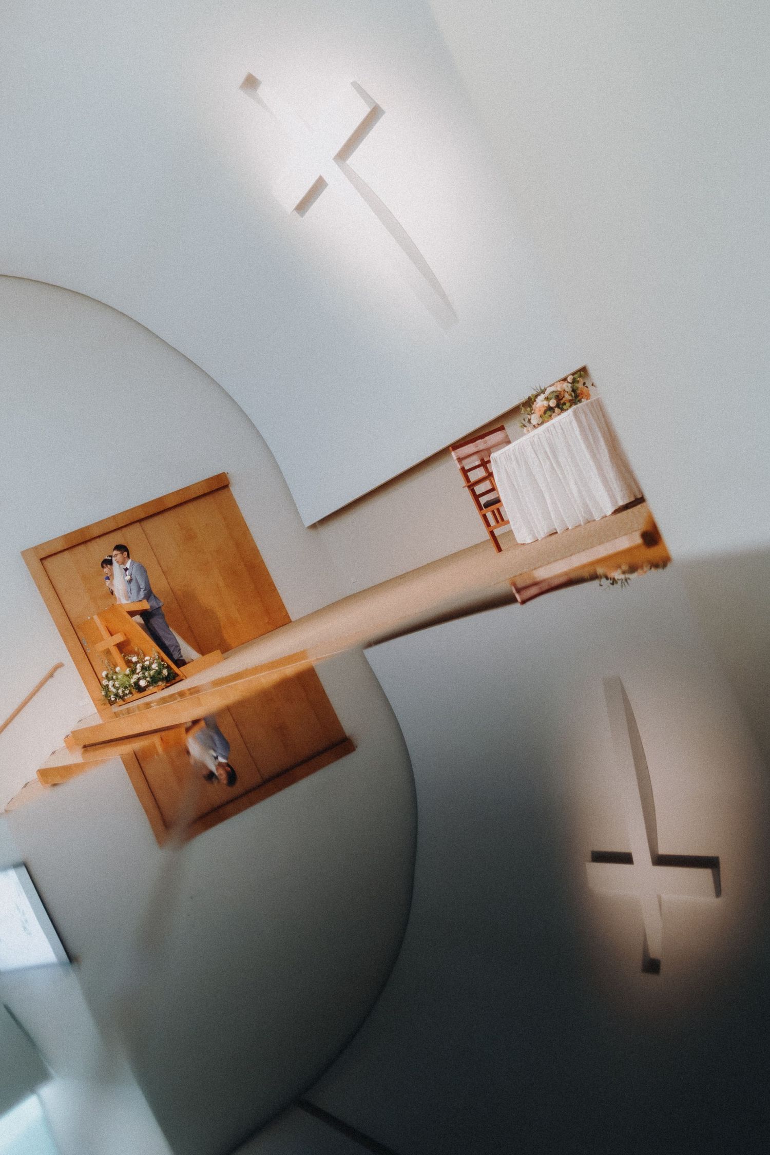 Time-lapse sequence showing a hanging wooden cabinet being installed on a white wall, viewed from below.