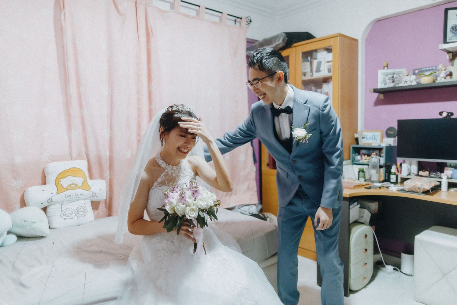 A sweet wedding day scene in a pink-walled room with white curtains.