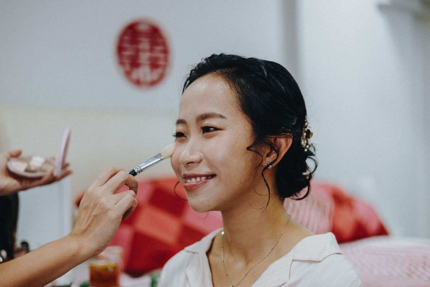 Happy guests in traditional Chinese wedding attire participate in customary tea ceremony rituals.