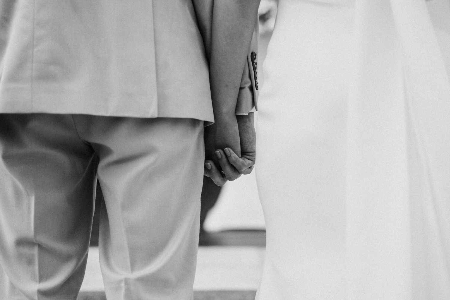 Minimalist wedding photography showing crisp white attire against neutral backgrounds.