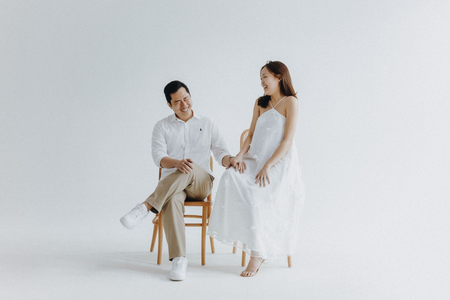 Wedding photoshoot showing various romantic poses between couple in elegant white outfits against light background.