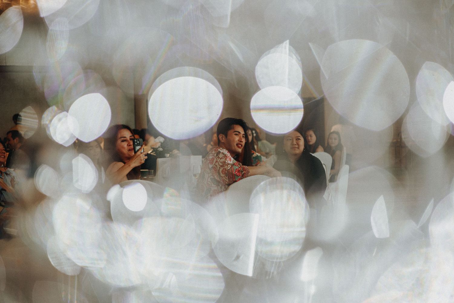 Dreamy bokeh lights creating a romantic atmosphere at an evening wedding reception.